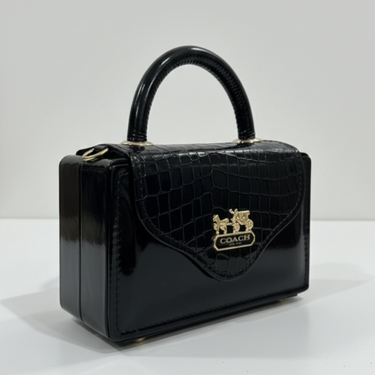 Black handbag with a visible brand logo on a white background