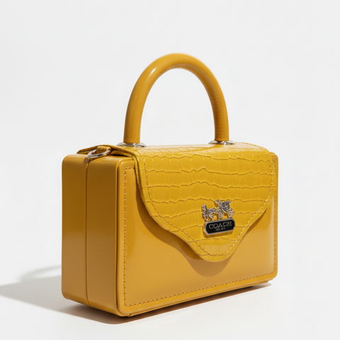 Yellow handbag with a visible brand logo on a white background