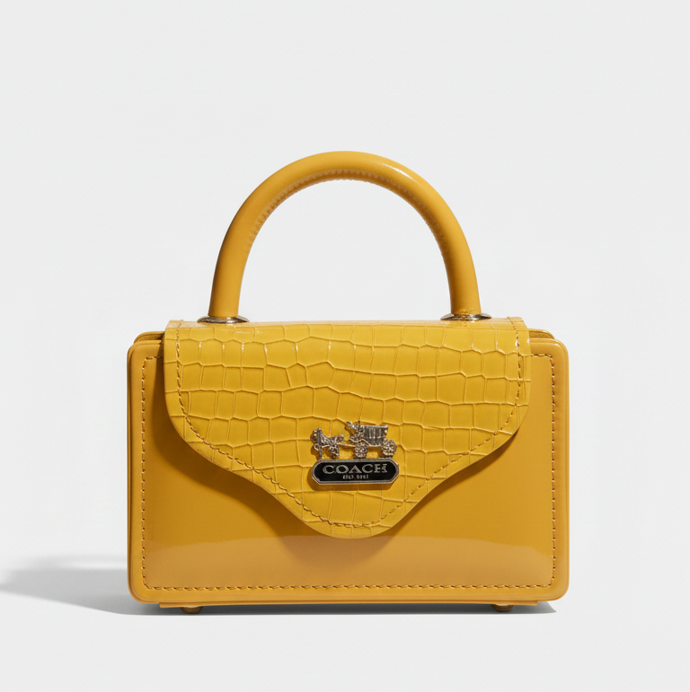 Yellow handbag with a brand logo on a light gray background