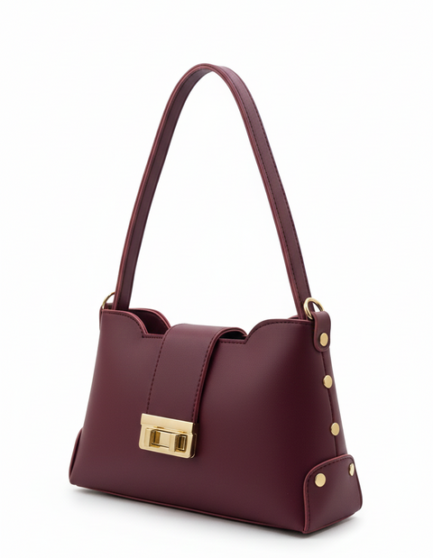 Burgundy handbag with gold accents on a white background